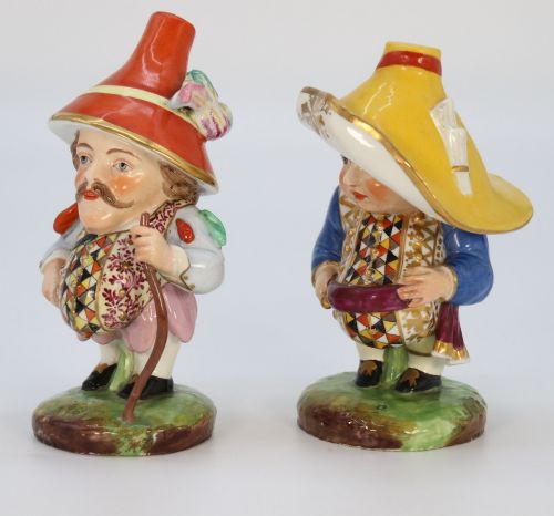 fig 1. A pair of 19th-century polychrome Samson porcelain figures depicting dwarves wearing oversized brimmed hats and patterned waistcoats on mound bases.