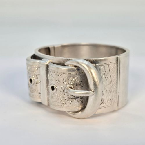 fig 2. A wide Victorian sterling silver hinged bangle crafted with a functional buckle motif and detailed hand-engraved foliage patterns.