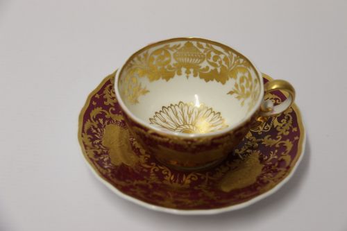 fig 1. An early nineteenth-century Regency Spode porcelain cabinet cup and saucer featuring deep crimson ground decorated with heavy gilded scrollwork and shell motifs.