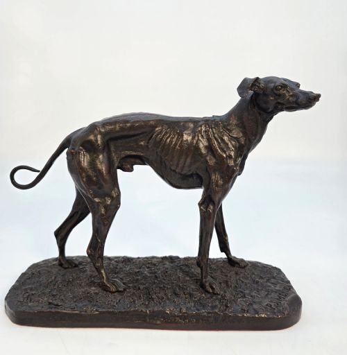 fig 1. A 19th-century dark patinated bronze sculpture of a standing greyhound dog on a textured oval base.