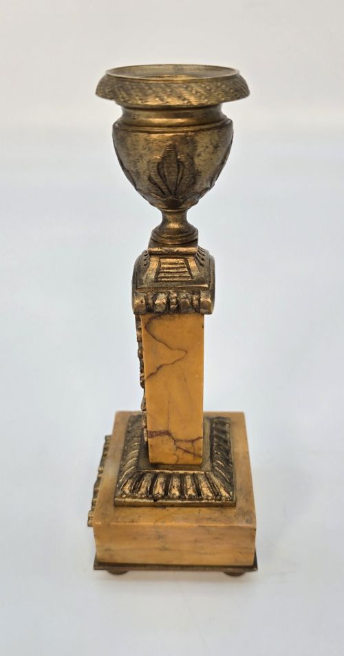fig 3. A pair of nineteenth-century French Empire gilt-bronze candlesticks featuring urn-shaped nozzles and applied bronze foliage on rectangular yellow marble bases.