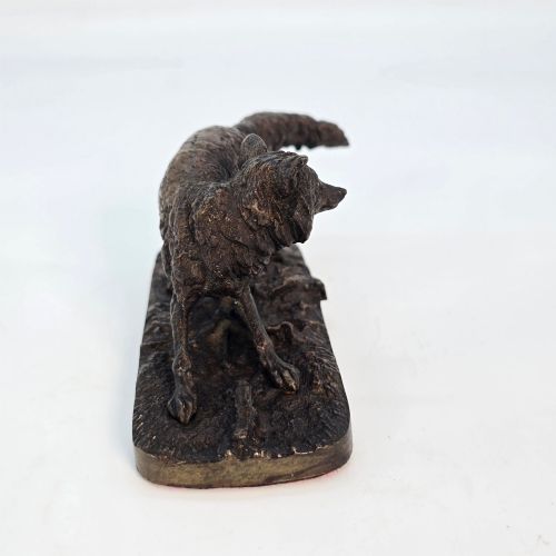 fig 2. A dark brown patinated bronze sculpture depicting a crouching fox on a naturalistic textured base.