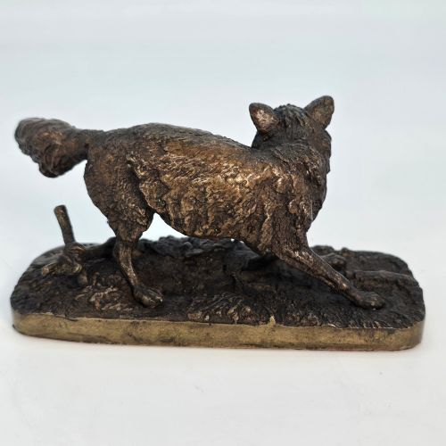 fig 3. A dark brown patinated bronze sculpture depicting a crouching fox on a naturalistic textured base.