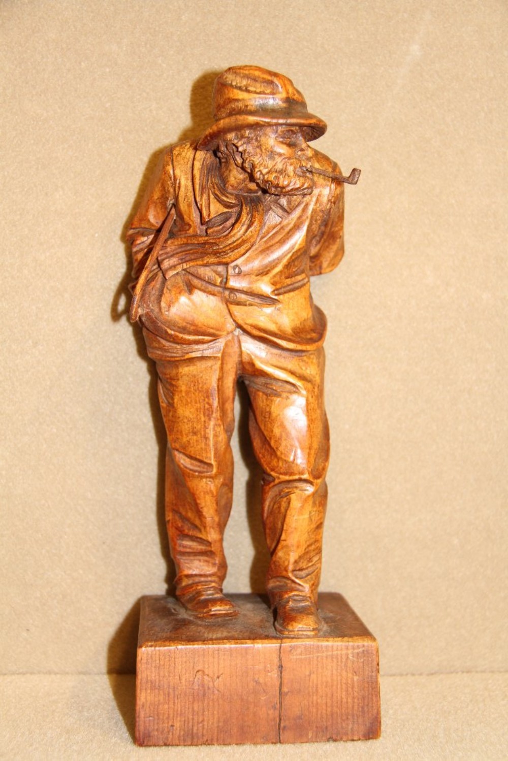A carved pine study of a windswept gentleman