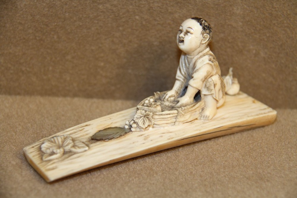 A Japanese Meiji period carved ivory Okimono