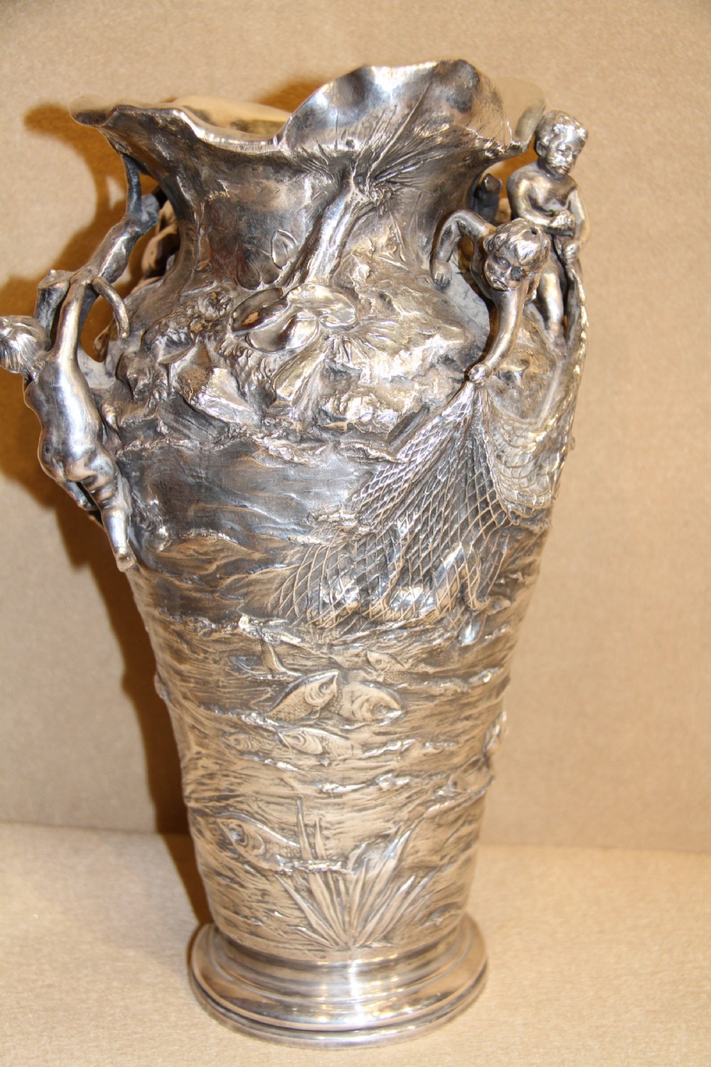A large and decorative silver plated vase embellished with water nymphs  casting their nets into a lake. View III