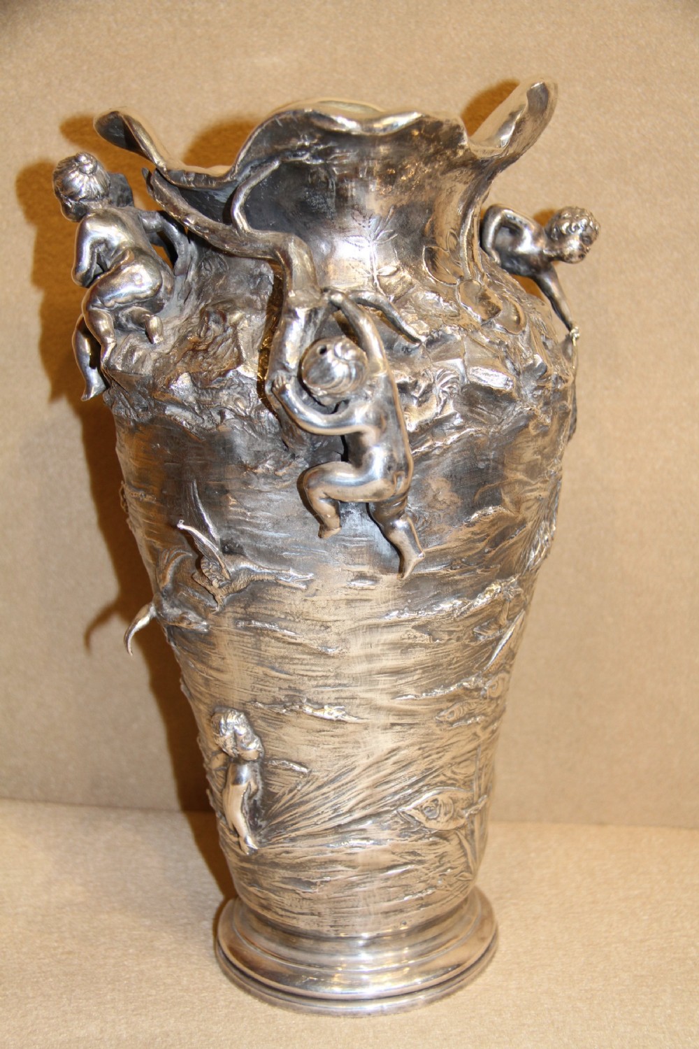 A large and decorative silver plated vase embellished with water nymphs  casting their nets into a lake. View IV