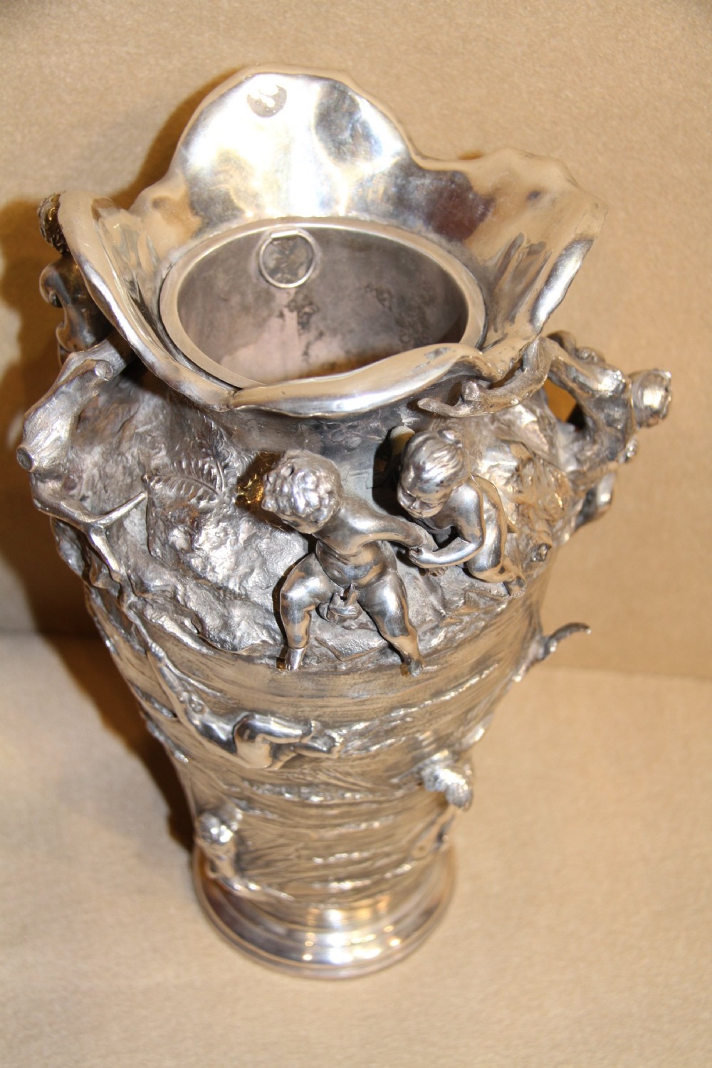 A large and decorative silver plated vase embellished with water nymphs  casting their nets into a lake. View VII