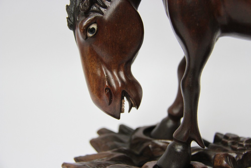 A 19th century Chinese carved hardwood study of a Horse View XII
