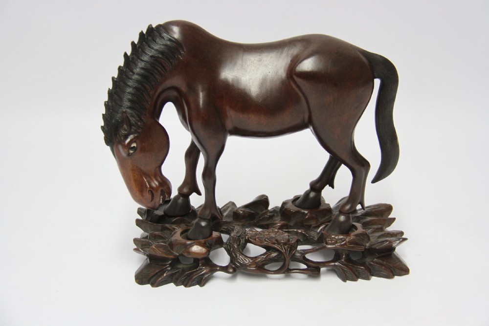 A 19th century Chinese carved hardwood study of a Horse View XIII