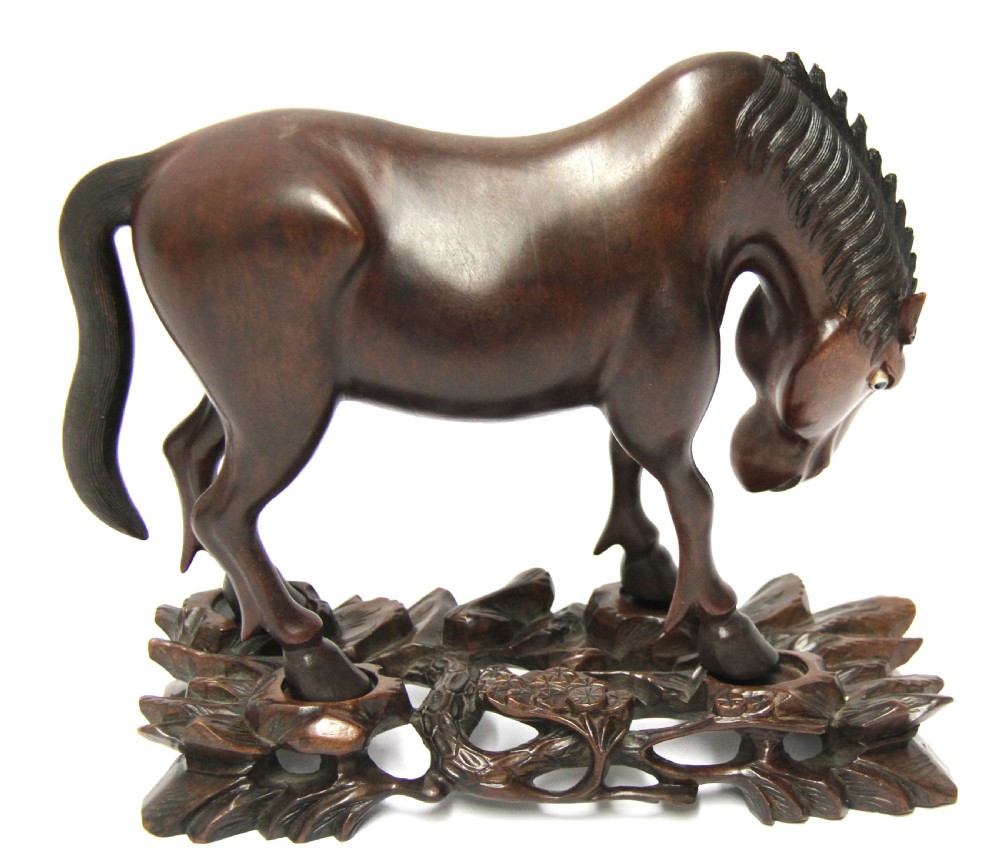 A 19th century Chinese carved hardwood study of a Horse View XVI