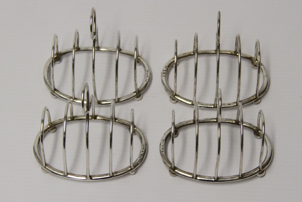 A rare set of four silver toast racks