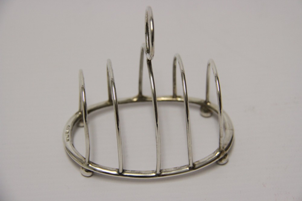 A rare set of four silver toast racks View VII