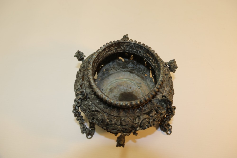 A dark patinated bronze hanging incense burner featuring dragon openwork motifs and a bird finial suspended by three link chains. View XIV