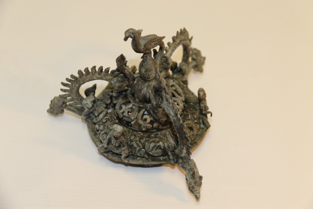 A dark patinated bronze hanging incense burner featuring dragon openwork motifs and a bird finial suspended by three link chains. View XVI
