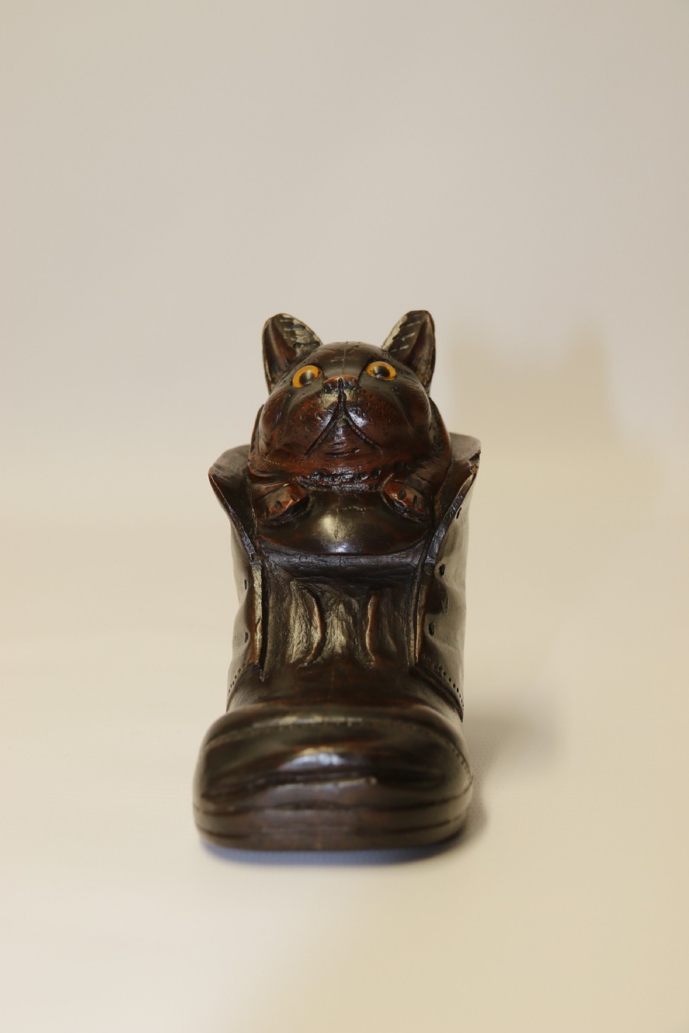 A Black Forest carved walnut kitten sitting in a boot View II