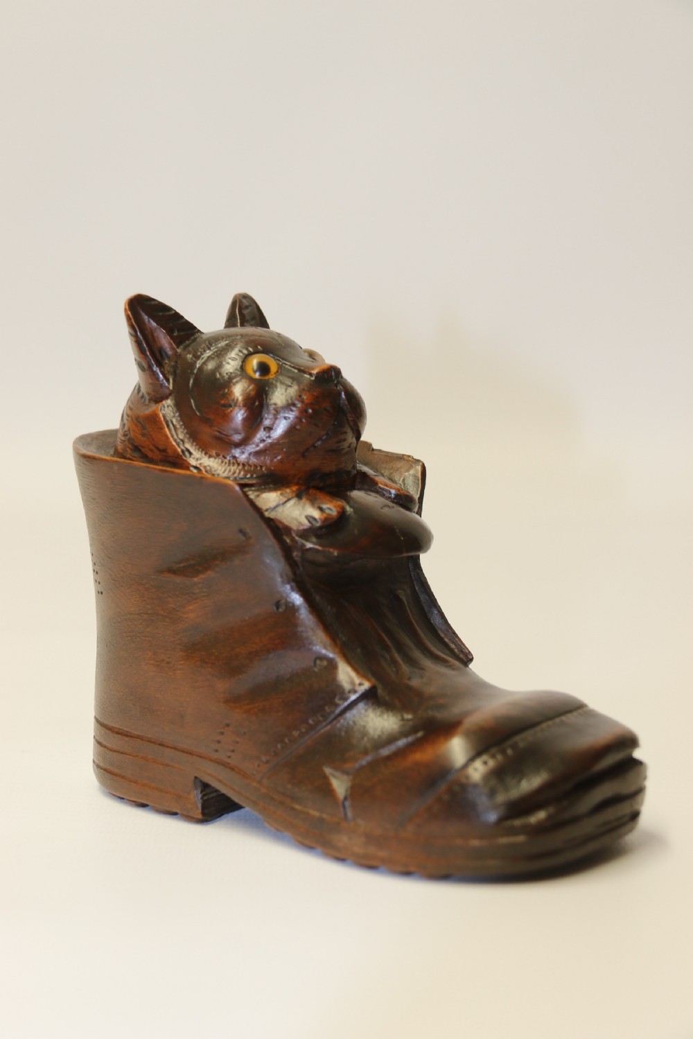 A Black Forest carved walnut kitten sitting in a boot View III
