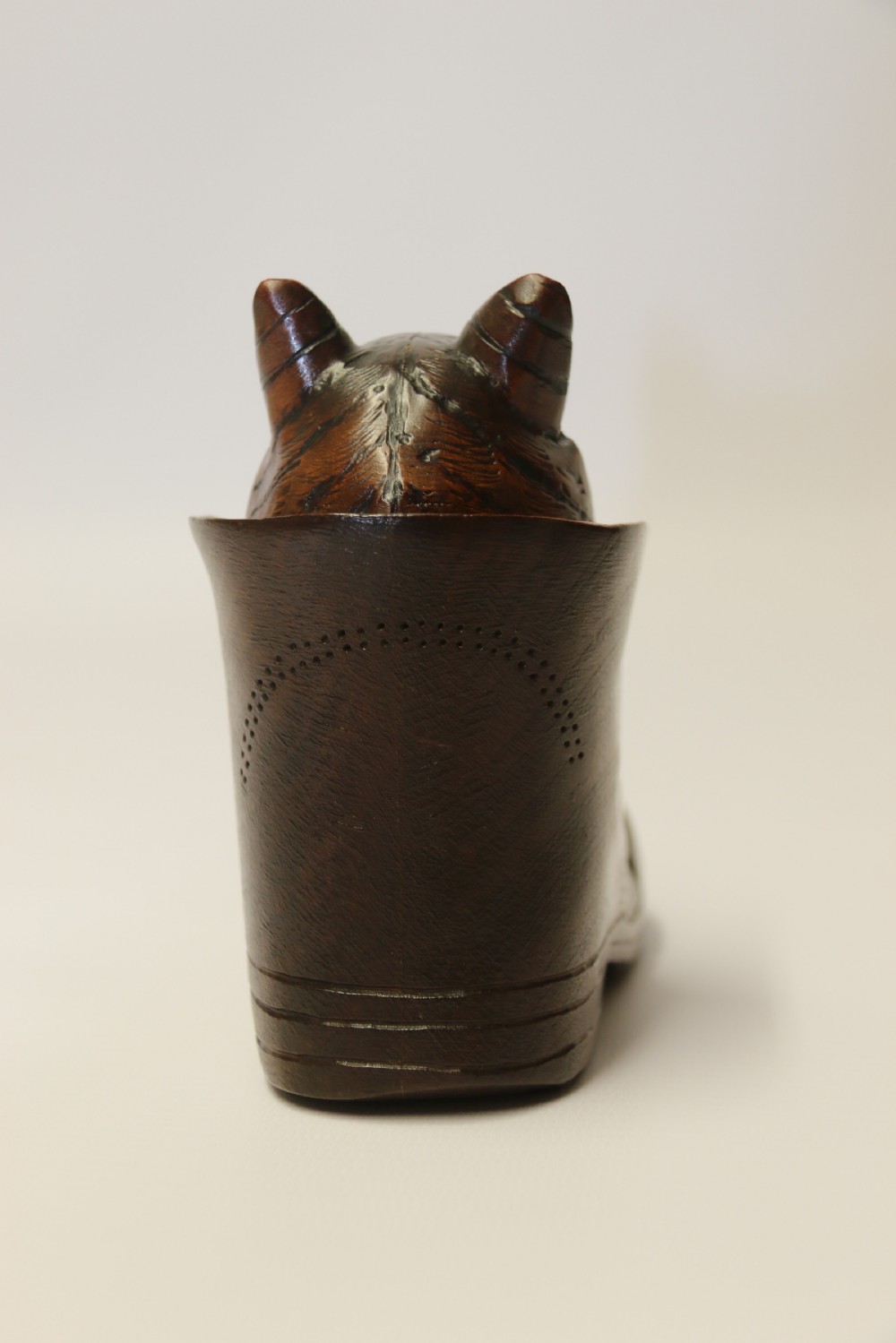 A Black Forest carved walnut kitten sitting in a boot View IV