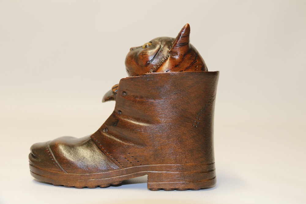 A Black Forest carved walnut kitten sitting in a boot View V