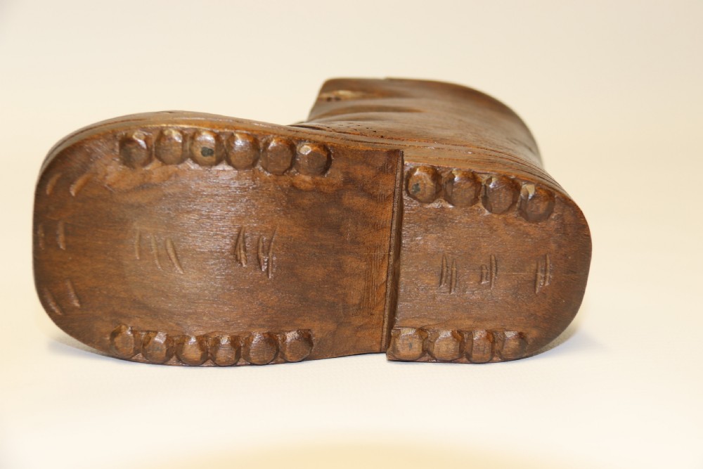 A Black Forest carved walnut kitten sitting in a boot View VIII
