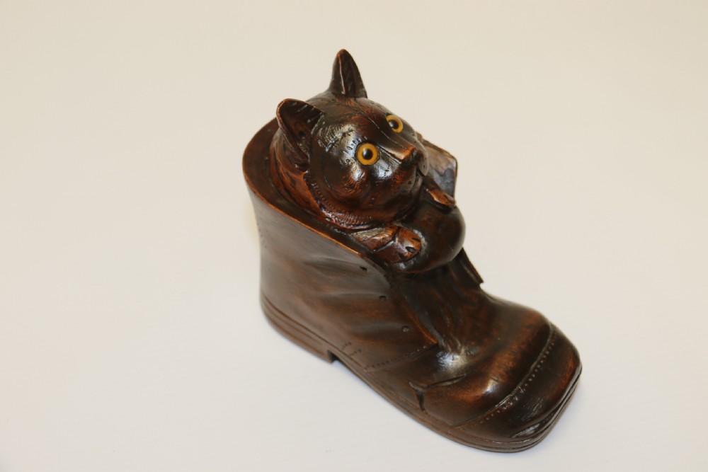 A Black Forest carved walnut kitten sitting in a boot View IX