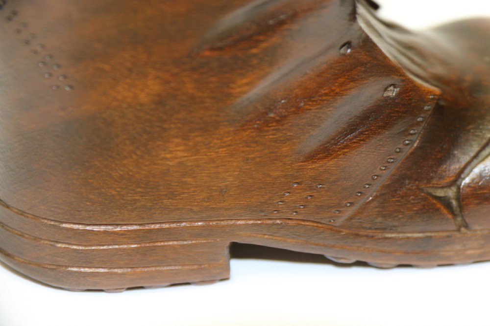 A Black Forest carved walnut kitten sitting in a boot View X