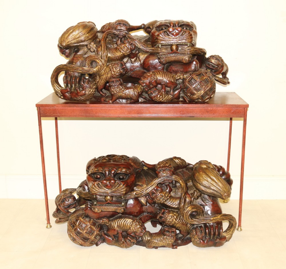 A rare pair of Chinese Mythical Beasts/Dogs of Foo on Stands