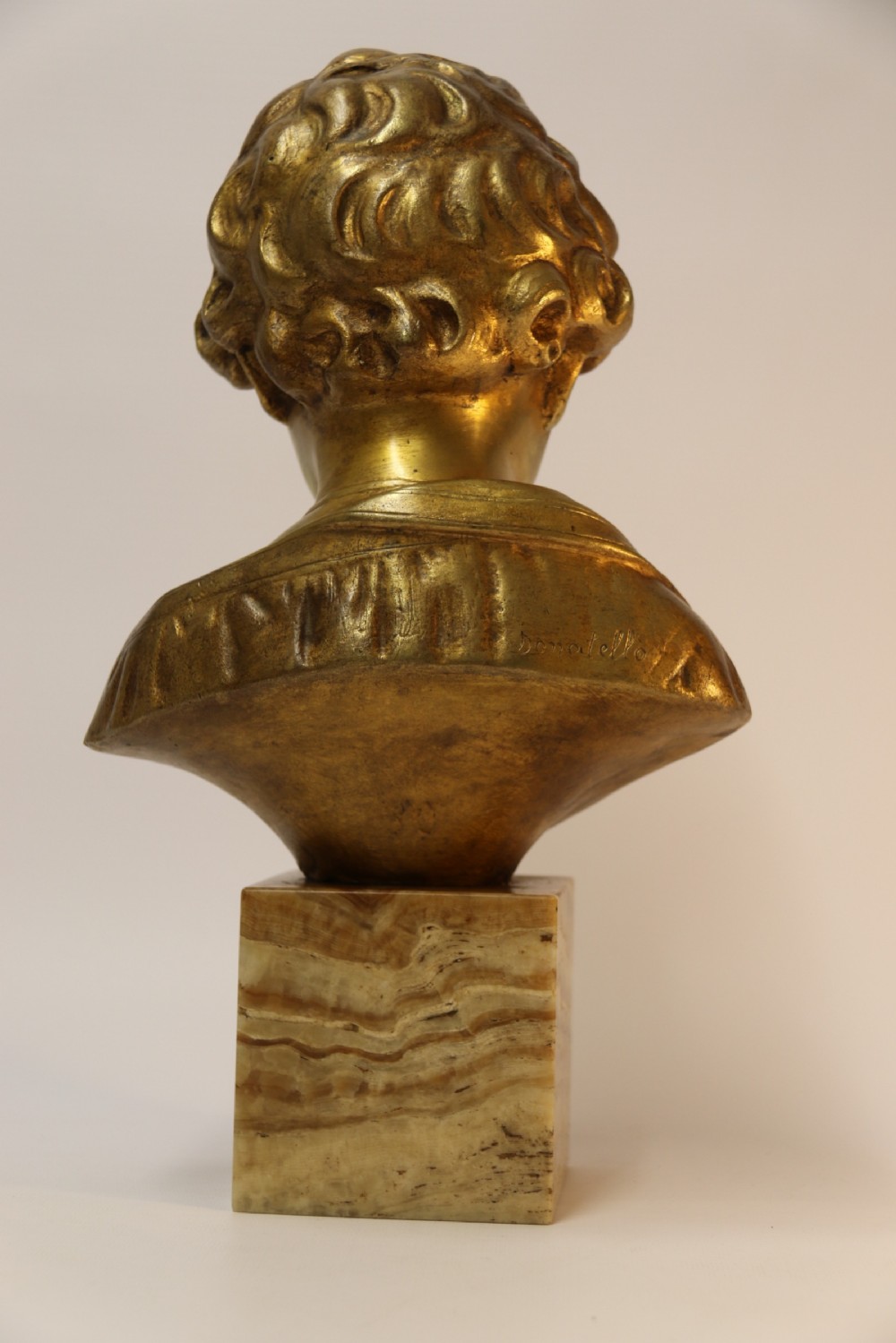 A gilt bronze bust of a boy after Donatello View V