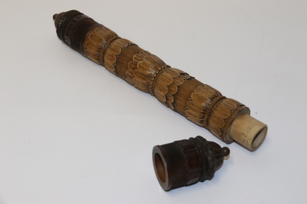 Two hand-carved fruitwood sewing cases featuring cylindrical shapes, leaf relief patterns, and turned finials. View III