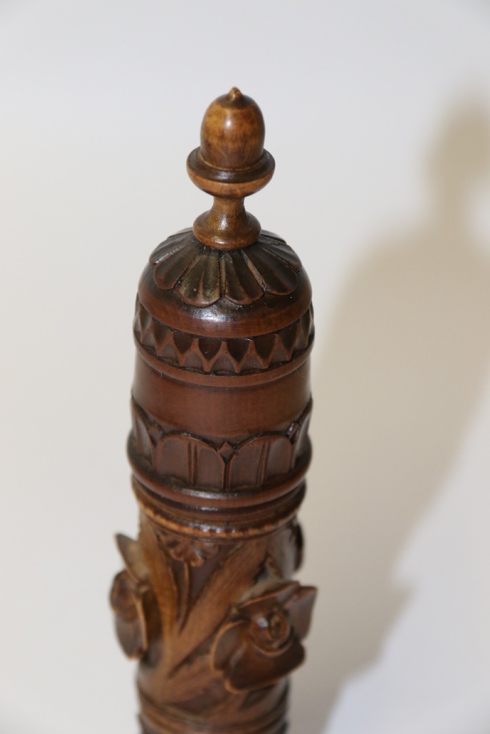Two hand-carved fruitwood sewing cases featuring cylindrical shapes, leaf relief patterns, and turned finials. View V