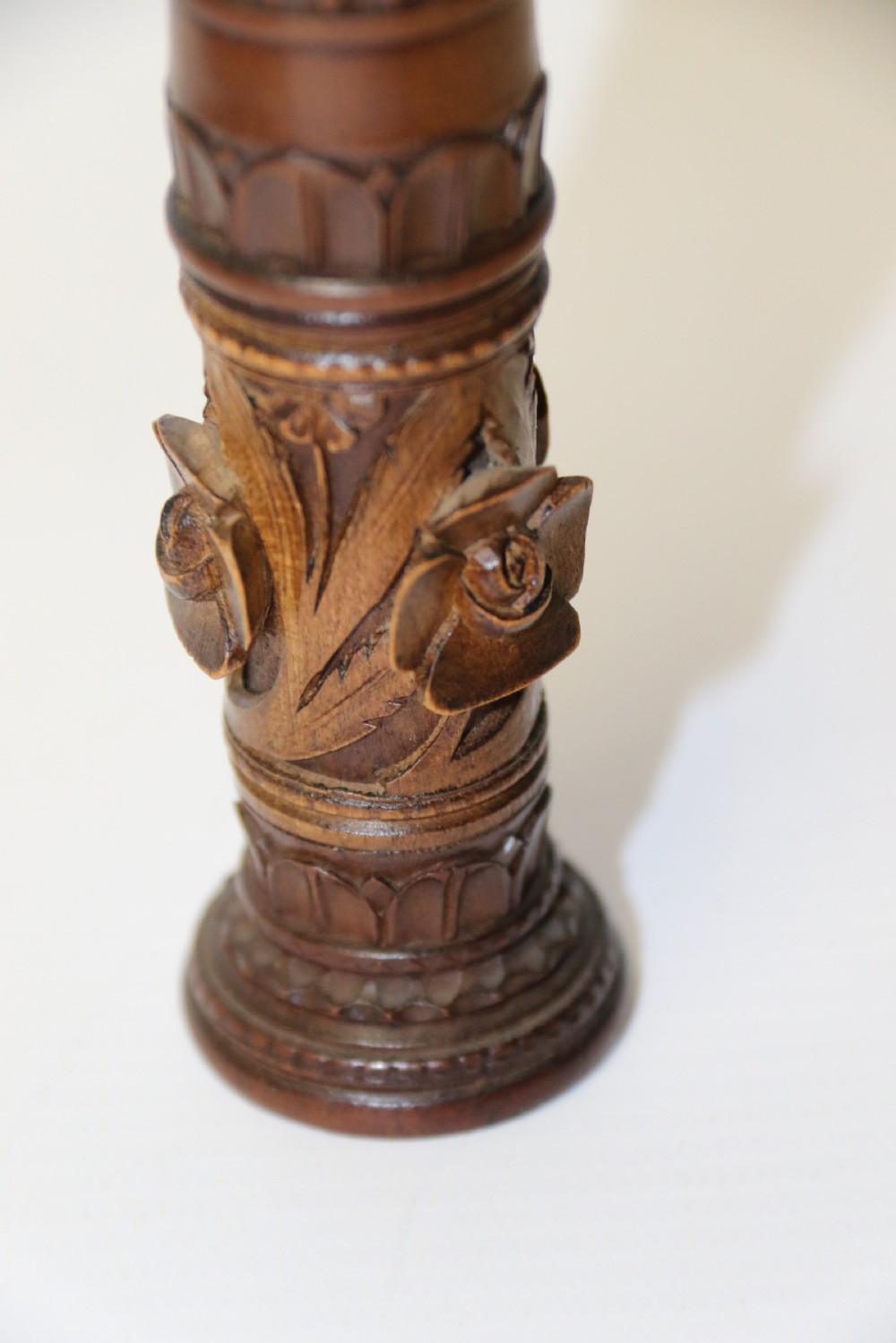 Two hand-carved fruitwood sewing cases featuring cylindrical shapes, leaf relief patterns, and turned finials. View VI