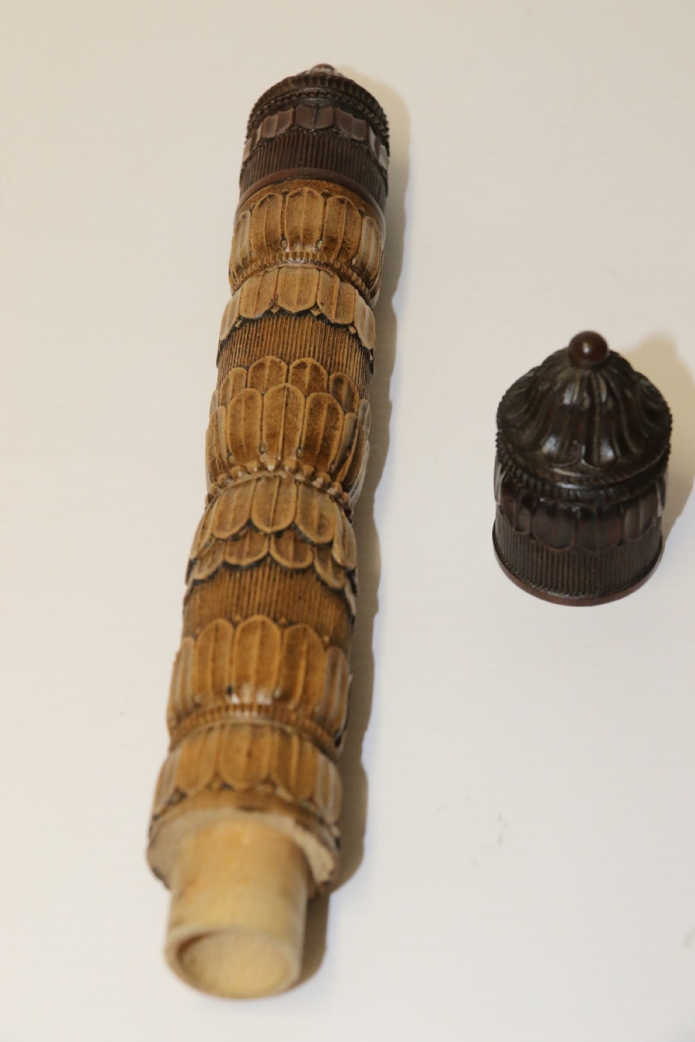 Two hand-carved fruitwood sewing cases featuring cylindrical shapes, leaf relief patterns, and turned finials. View VII