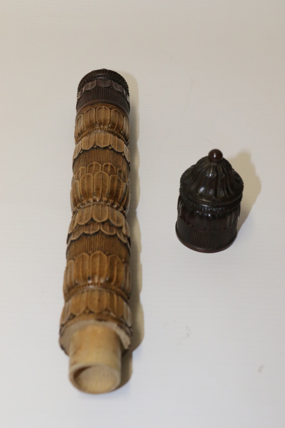 Two hand-carved fruitwood sewing cases featuring cylindrical shapes, leaf relief patterns, and turned finials. View VIII