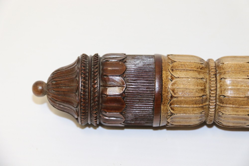 Two hand-carved fruitwood sewing cases featuring cylindrical shapes, leaf relief patterns, and turned finials. View IX