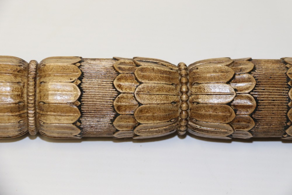 Two hand-carved fruitwood sewing cases featuring cylindrical shapes, leaf relief patterns, and turned finials. View X