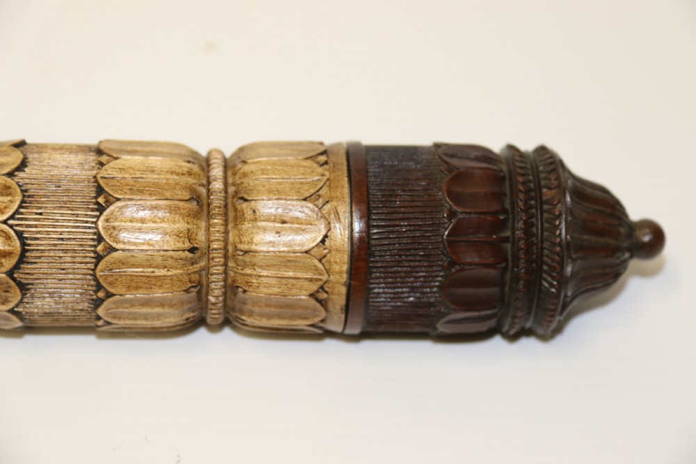Two hand-carved fruitwood sewing cases featuring cylindrical shapes, leaf relief patterns, and turned finials. View XI
