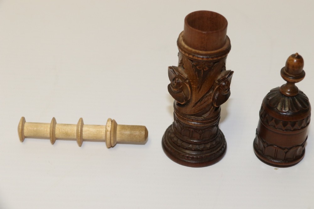 Two hand-carved fruitwood sewing cases featuring cylindrical shapes, leaf relief patterns, and turned finials. View XIII