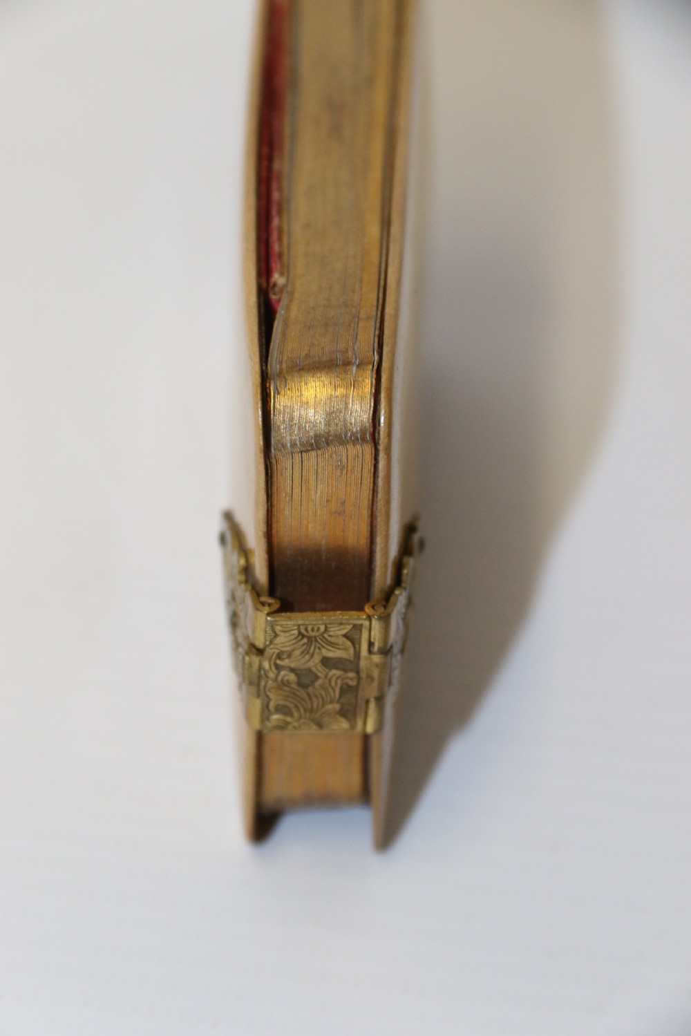 An antique Victorian Mauchline ware wooden pocket notebook displaying a black oval transfer print depicting the Arcades at Crystal Palace, featuring an ornate brass top clasp. View V