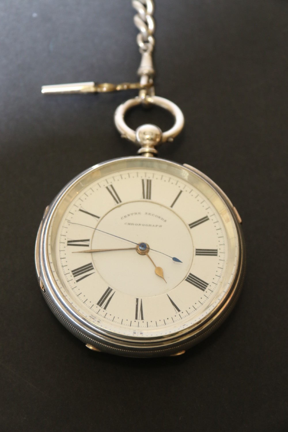 An Over sized Silver Chronograph Pocket Watch and Chain with Mining Tug of War Fob. View II