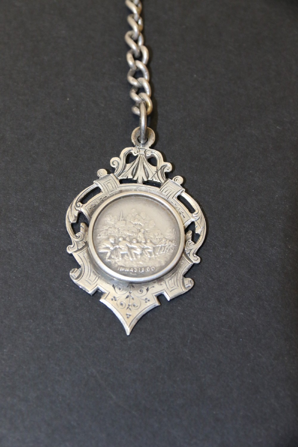 An Over sized Silver Chronograph Pocket Watch and Chain with Mining Tug of War Fob. View III