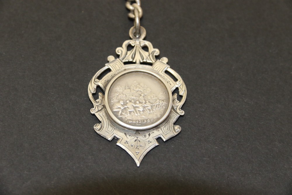 An Over sized Silver Chronograph Pocket Watch and Chain with Mining Tug of War Fob. View IV