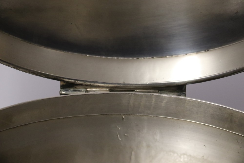 A polished silver-plated oval box featuring a smooth domed lid and rope-twist borders around the rim and base. View VIII