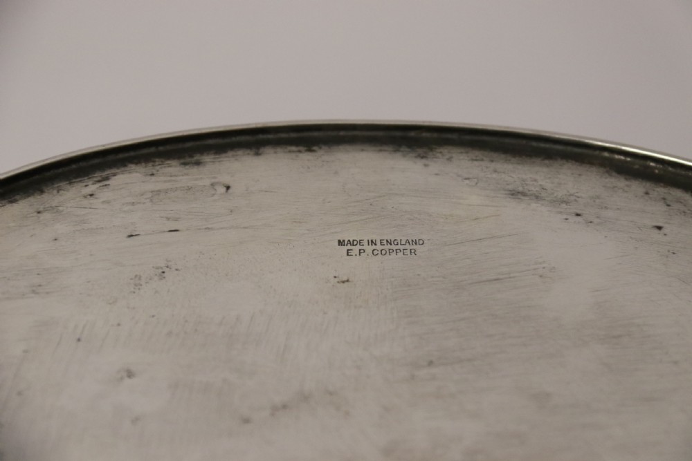A polished silver-plated oval box featuring a smooth domed lid and rope-twist borders around the rim and base. View XII