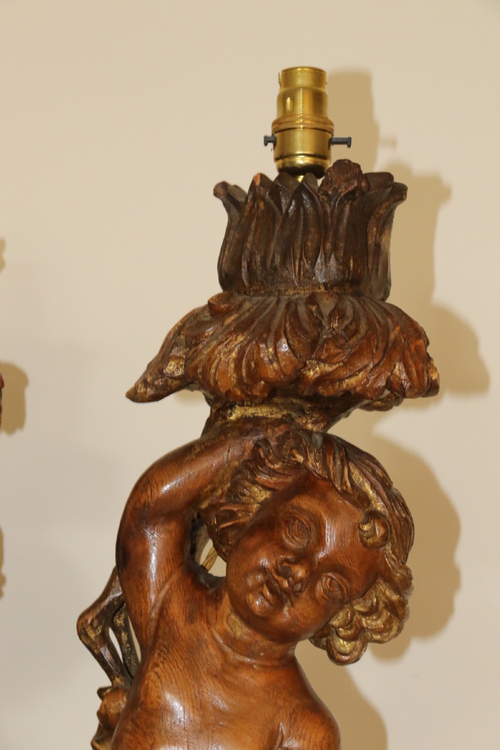 A large pair of carved wooden cherub lamps   View II