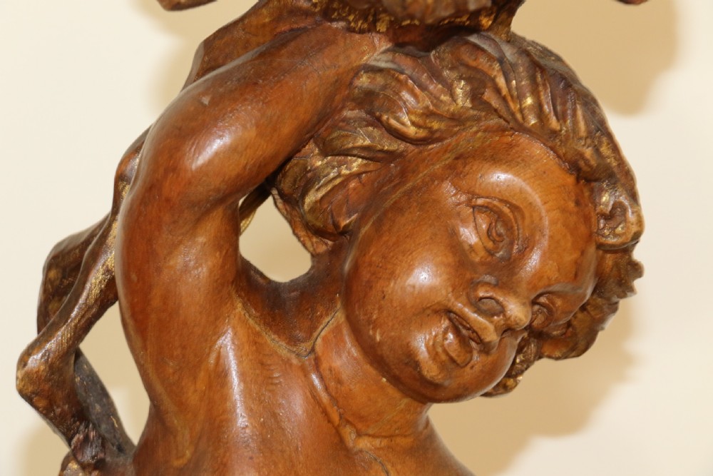 A large pair of carved wooden cherub lamps   View IV