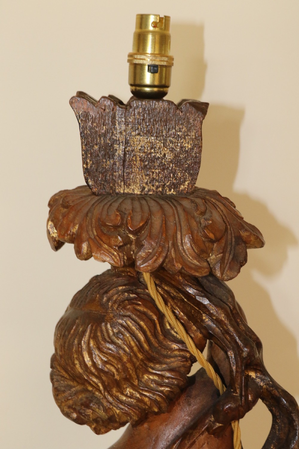 A large pair of carved wooden cherub lamps   View V