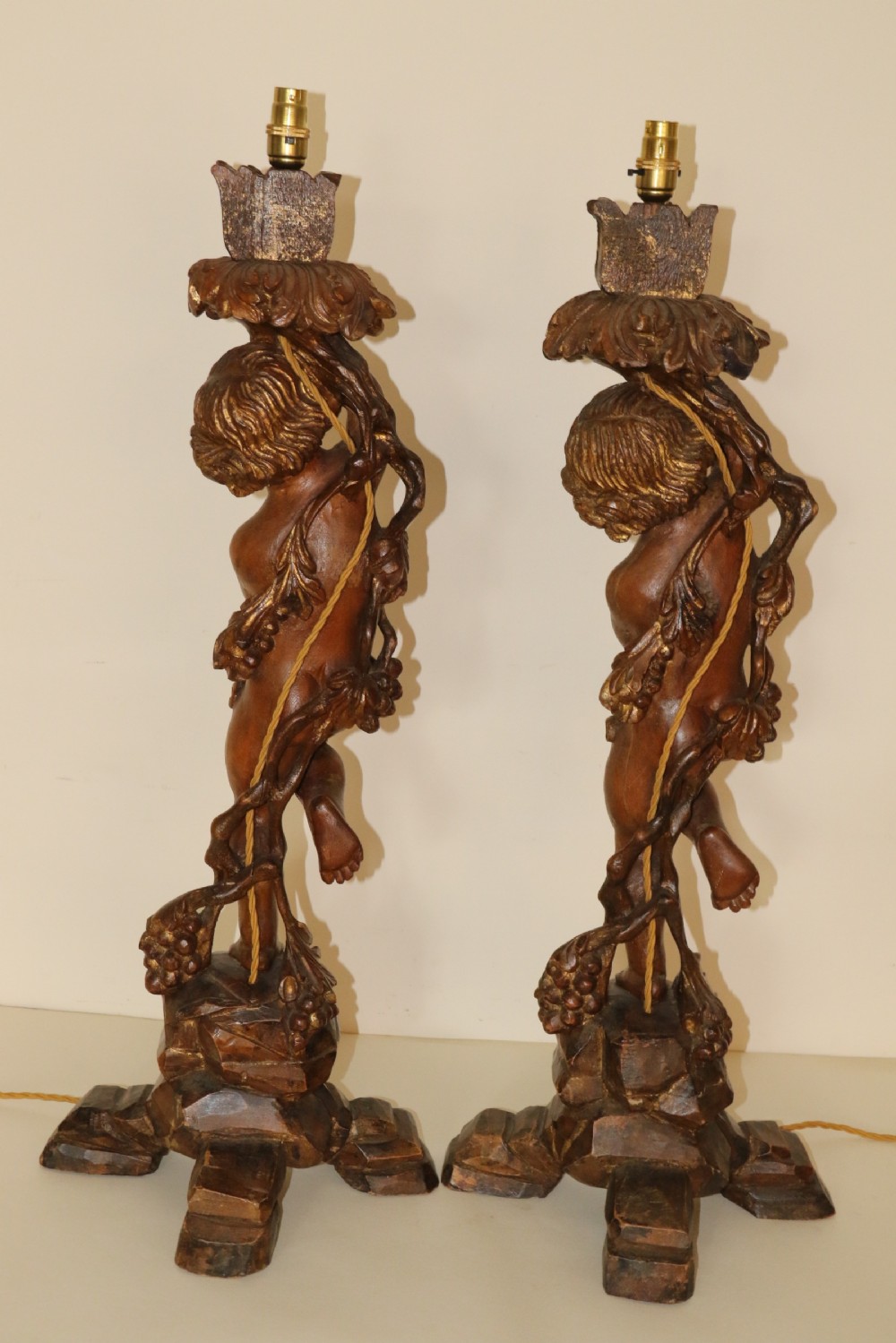 A large pair of carved wooden cherub lamps   View VI