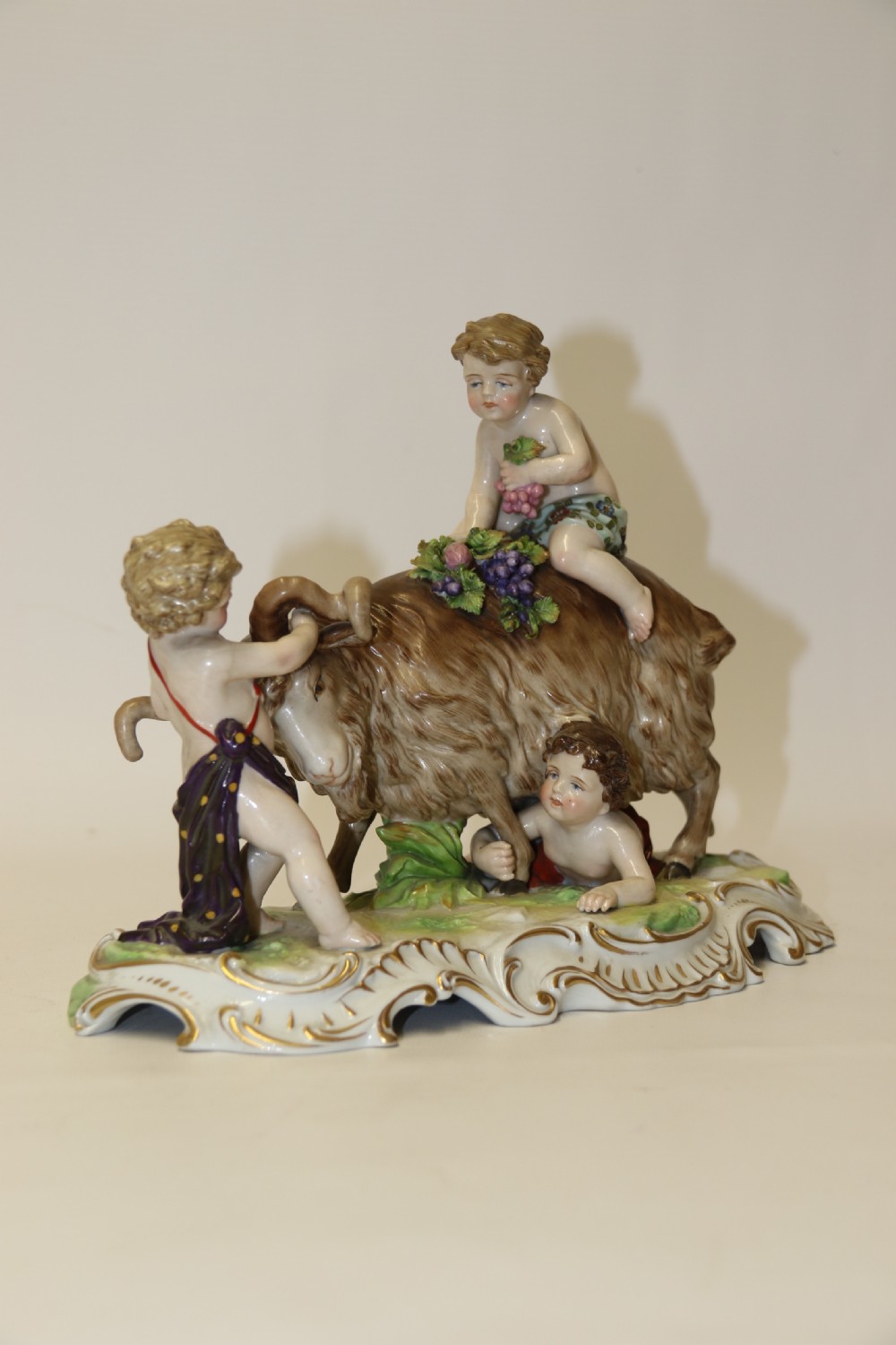 A fine Porcelain Figure Group of three Putti Wrestling with a Goat by Hochst Factory View II