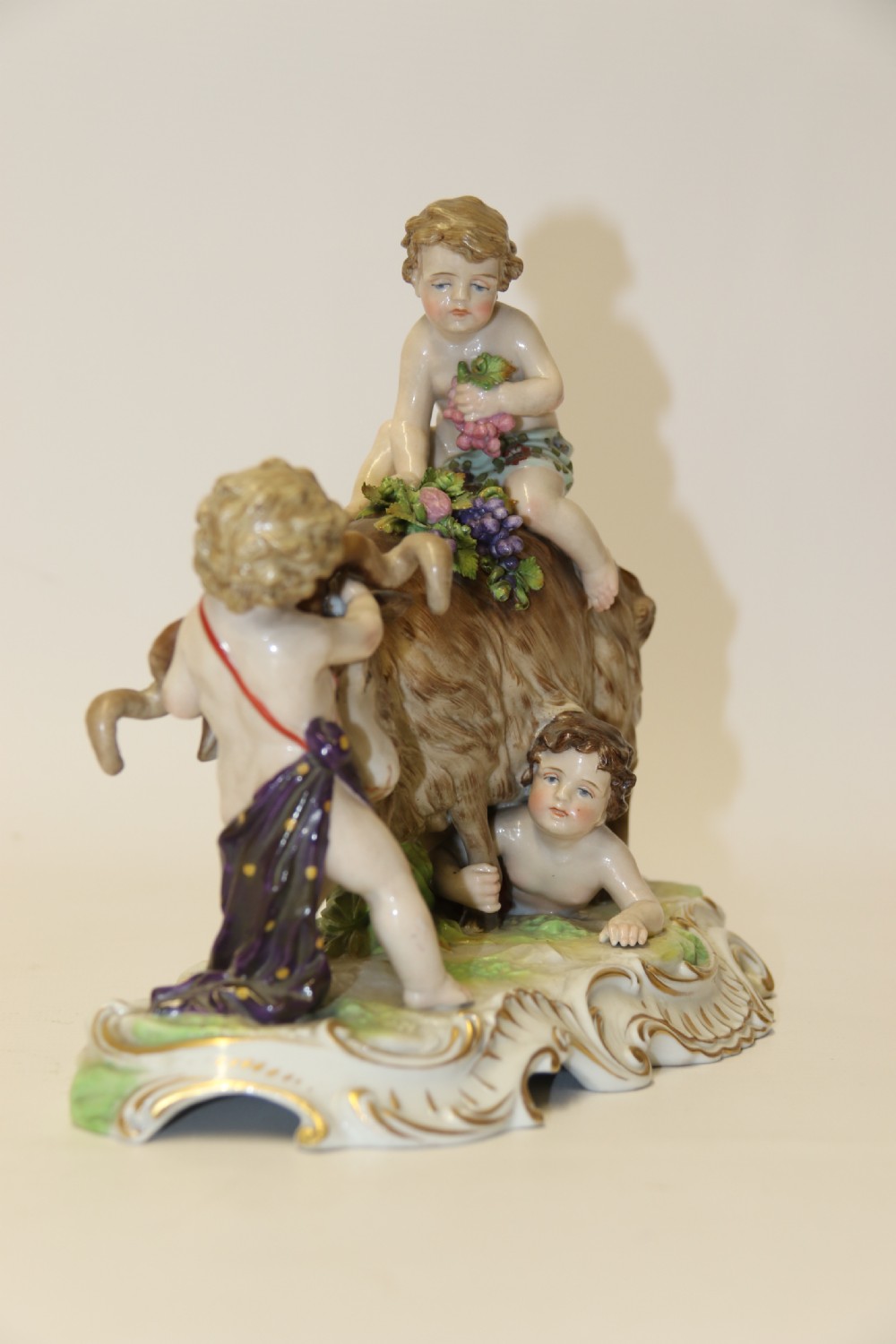A fine Porcelain Figure Group of three Putti Wrestling with a Goat by Hochst Factory View III