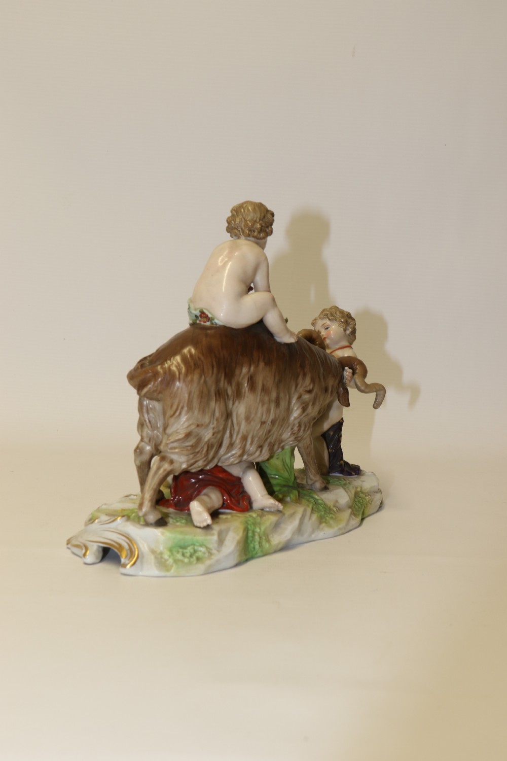 A fine Porcelain Figure Group of three Putti Wrestling with a Goat by Hochst Factory View VI